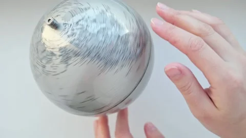 Hand rotates a gray Globe and selects a random point on the map. Manuscript Stock Footage 225828935