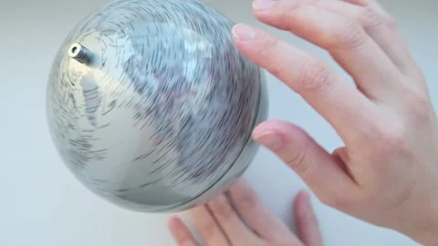 Hand rotates a gray Globe and hugs the map. Manuscript globe, representing 3 Stock Footage 225829238