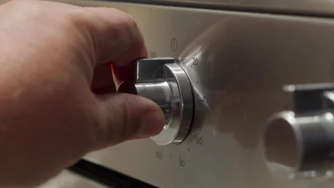 Hand Rotates Oven Timer Knob to Set Cooking Duration with Loud Click Stock Footage 321205088