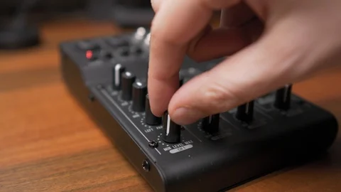 Hand rotating black knobs on mini dj mixing console, Shallow Focus 動画素材 118732778