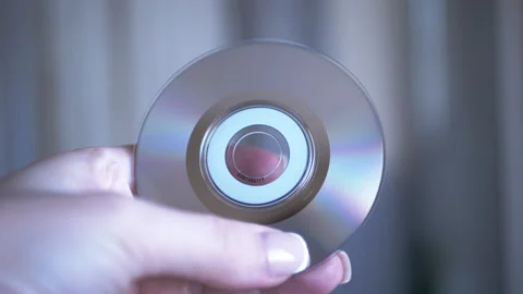 Hand Rotating CD in Light Stock Footage 312009577