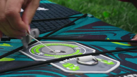Hand Rotating Inflation-Deflation Valve on Inflatable Stand-Up Paddleboard Stock Footage 345618069