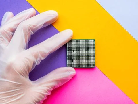 Hand in rubber glove with Central Computer Processor. CPU on geometric backgr Stock Photos