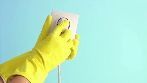 Hand in rubber glove insert plug into electrical socket and showing thumb up Stock Footage 148655911