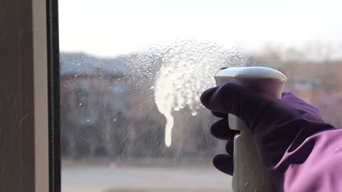 Hand in a rubber glove washes the window. High quality FullHD footage. Stock Footage 146273126
