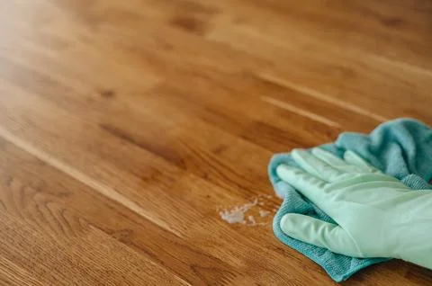 Hand in rubber gloves wiping surface with yellow rag, home cleaning and hou.. Stock Photos