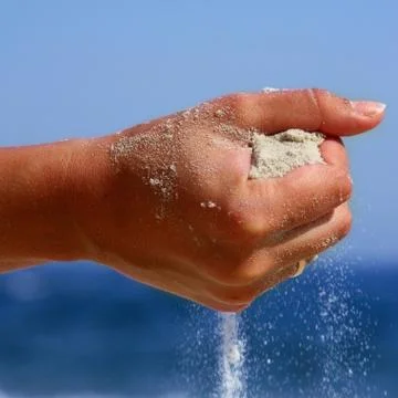 Hand with the sand Stock Photos