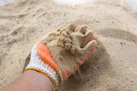 Hand with sand Stock Photos