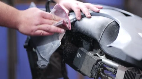 Hand Sanding Motorcycle Plastic Part with Filler on Seat Close Up Video stock 331675119