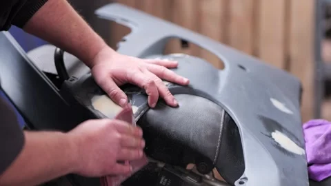 Hand Sanding Motorcycle Plastic Part with Filler on Seat Close Up Stock Footage 331675176