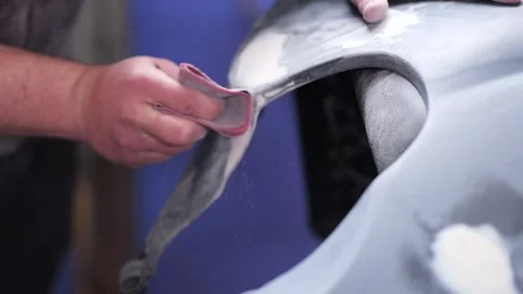 Hand Sanding Motorcycle Plastic Part with Filler on Seat Close Up Stock Footage 331675229