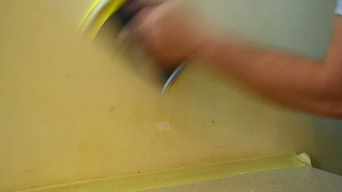 Hand sanding painted wall patch near countertop in interior Stock Footage 335314479