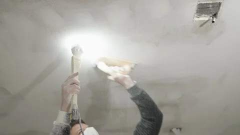 Hand sanding of the plasterboard ceiling with a trowel Stock Footage 234972533