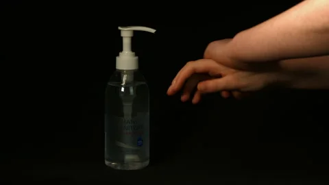 Hand sanitiser being used on black background Pt 1 of 4 Stock Footage 149694153