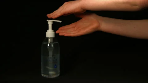 Hand sanitiser being used on black background Pt 3 of 4 Stock Footage 149695103