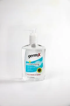 Hand sanitizer bottle with moisturizing formula placed on neutral background for Stock Photos