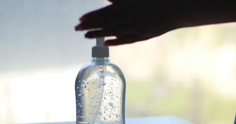Hand sanitizing with alcohol gel in bottle Stock Footage 141557775