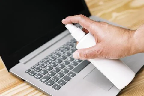 Hand sanitizing computer with antibacterial spray Stock Photos