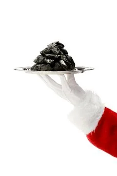 Hand of Santa Clause with tray of coal Foto stock