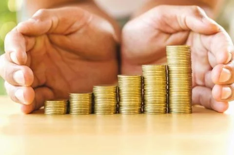 Hand save money with stack money coin for growing graph your business Stock Photos