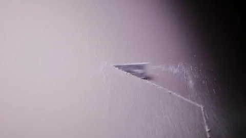 Hand Saw Cutting Drywall Board In Workshop Under Focused Light Beam Stock Footage 320097217