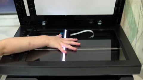 Hand scanning process. The scanner in operation scans a child's hand with the Stock Footage 146320219