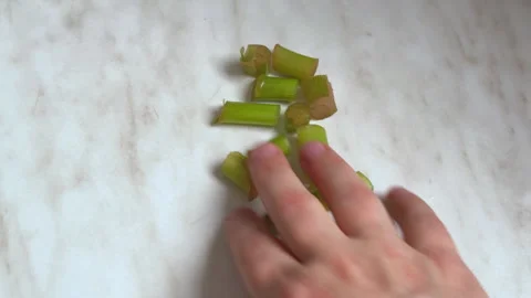 Hand scattering cut flower stalks on a marble countertop Stock Footage 341273764