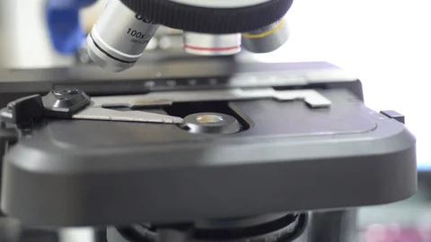 Hand scientis using microscope in laboratory. Stock Footage 105856431