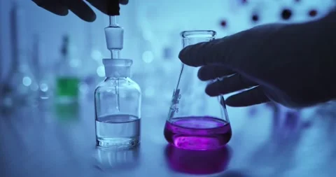 Hand scientist shaking Erlenmeyer flask with chemical liquid Stock Footage 159414715
