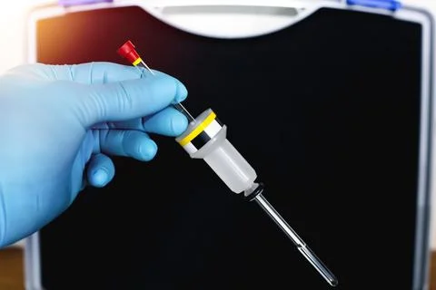 Hand of the scientist shows a sample solution in NMR tube with a spinner. S.. Stock Photos