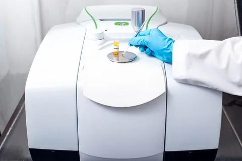 Hand of the scientist using a stainless spatula to scoop sample solid from .. Stock Photos