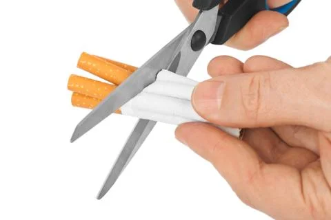Hand with scissors and cigarettes Stock Photos