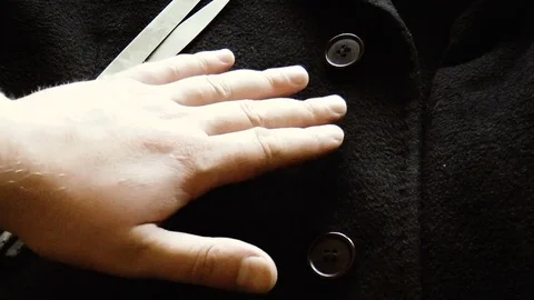 Hand scissors coat Stock Footage 79409224