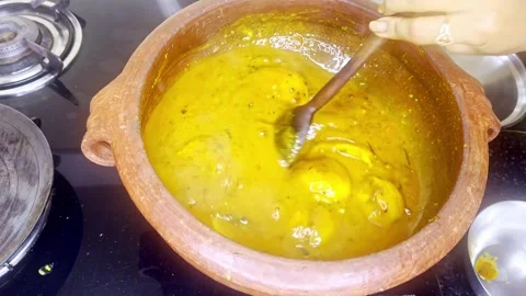 Hand scoop veggie chunks into small bowl in indian kitchen Stock Footage 313277032