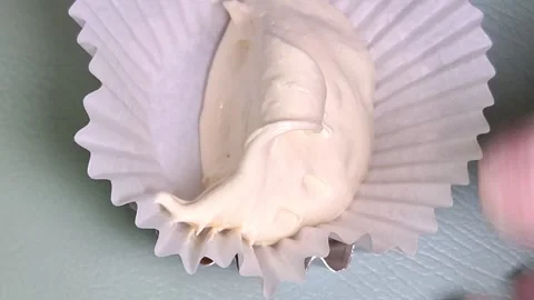 Hand Scooping Cake Batter into Paper Cup Liner for Baking Stock-Footage 347881929