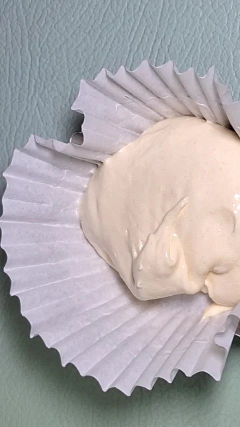 Hand Scooping Cake Batter into Paper Cup Liner for Baking Stock-Footage 347881948