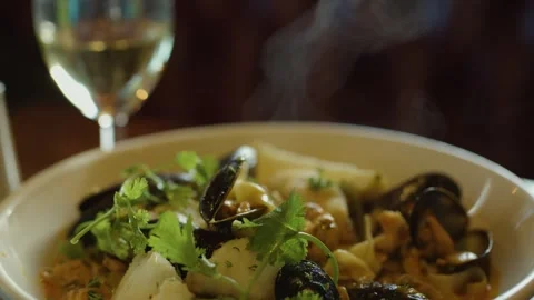 Hand Scooping Steaming Seafood Chowder with White Wine Stock Footage 314491368