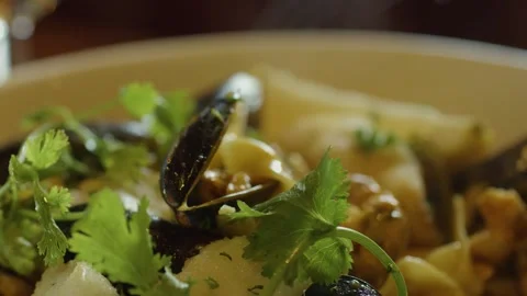 Hand Scooping Steaming Seafood Chowder With Fresh Herbs Stock Footage 314692841