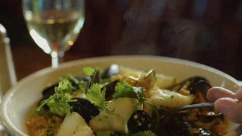 Hand Scooping Steaming Seafood Chowder in Warm Restaurant Light Stock Footage 315017969