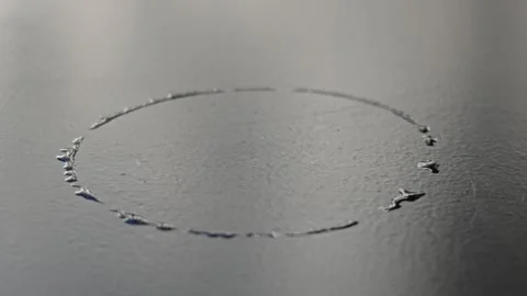 Hand-scratched circle gradually completing on brushed gray metallic surface Stock Footage 344746804