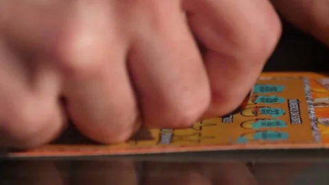 Hand scratching a lottery ticket 4k Stock Footage