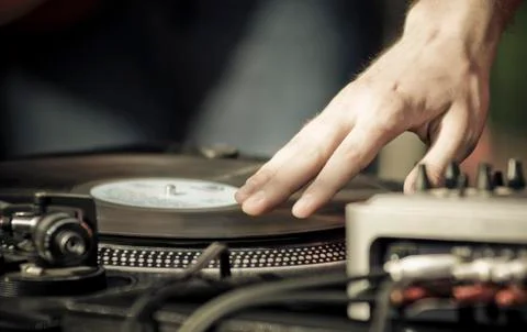 Hand scratching a record on a turntable. Stock Photos
