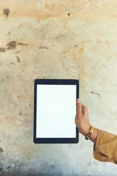 Hand, screen and tablet with blank mockup on wall background for advertisin.. Stock Photos