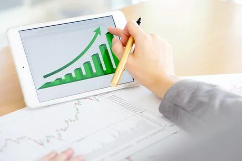 Hand on screen tablet pc with business information Stock Photos