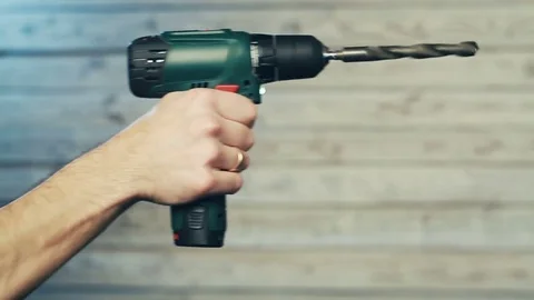 The hand with a screwdriver drills the void Stockbeeldmateriaal 83236543