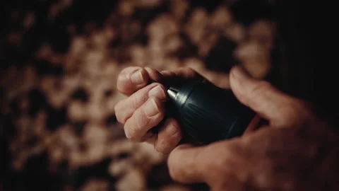 Hand screwing a drill bit into an electric drill with a wooden background Stock Footage 139755152
