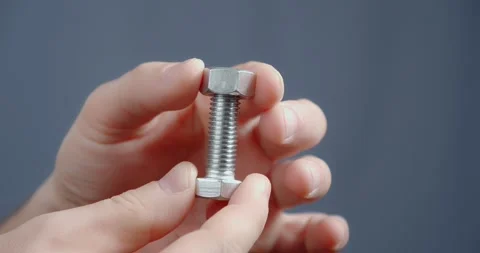 The hand screws the nut on the bolt close-up. 스톡 동영상 169493385