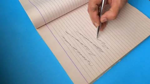 Hand scribbles uneven lines with pen on clean empty page close up Stock Footage 313629266