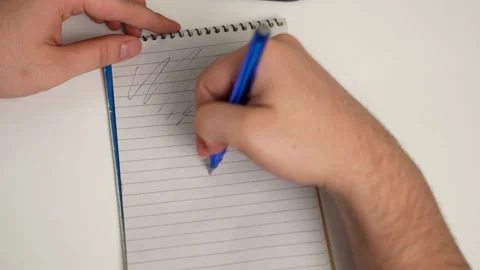 Hand scribbling random lines on notebook page Stock Footage 316233760