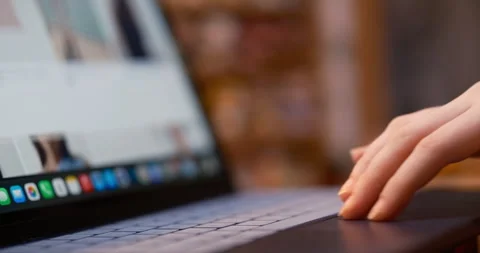 Hand scrolling across touchpad modern premium laptop, online shopping session Stock Footage 334419091